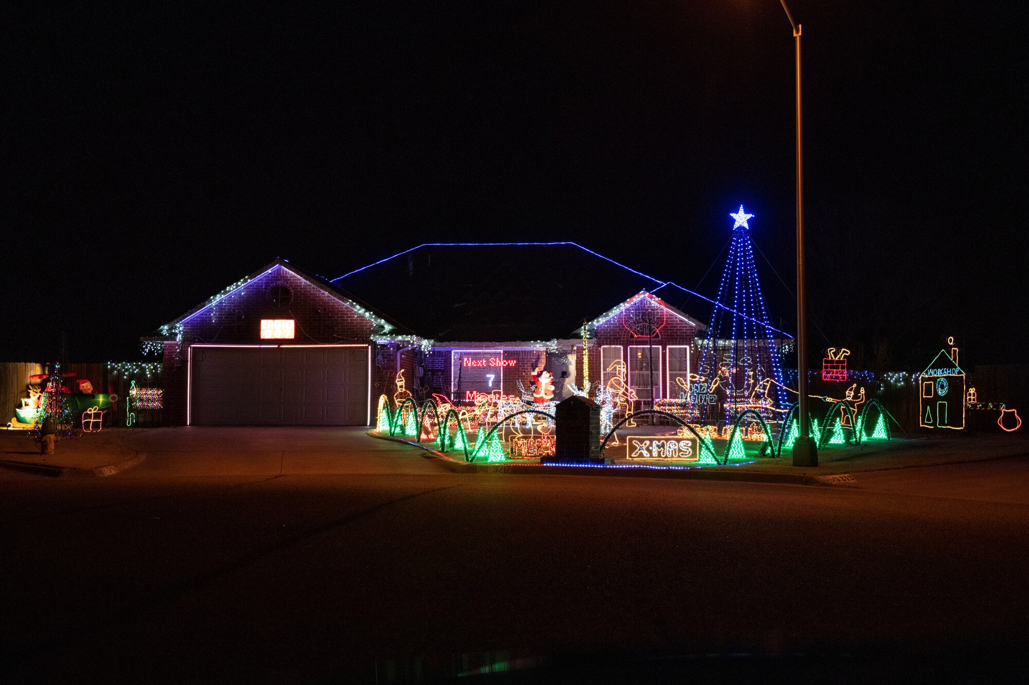 Military family displays holiday lights.