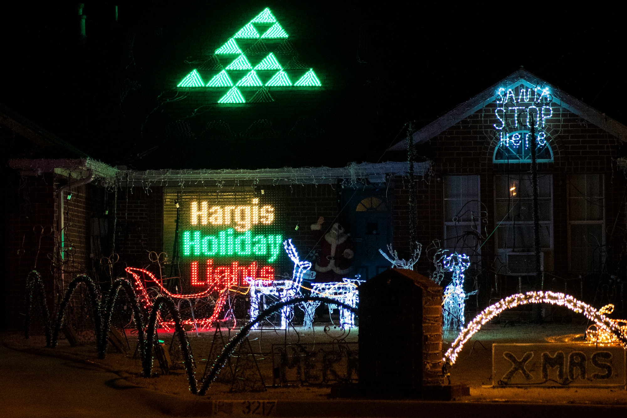 Military family displays holiday lights.