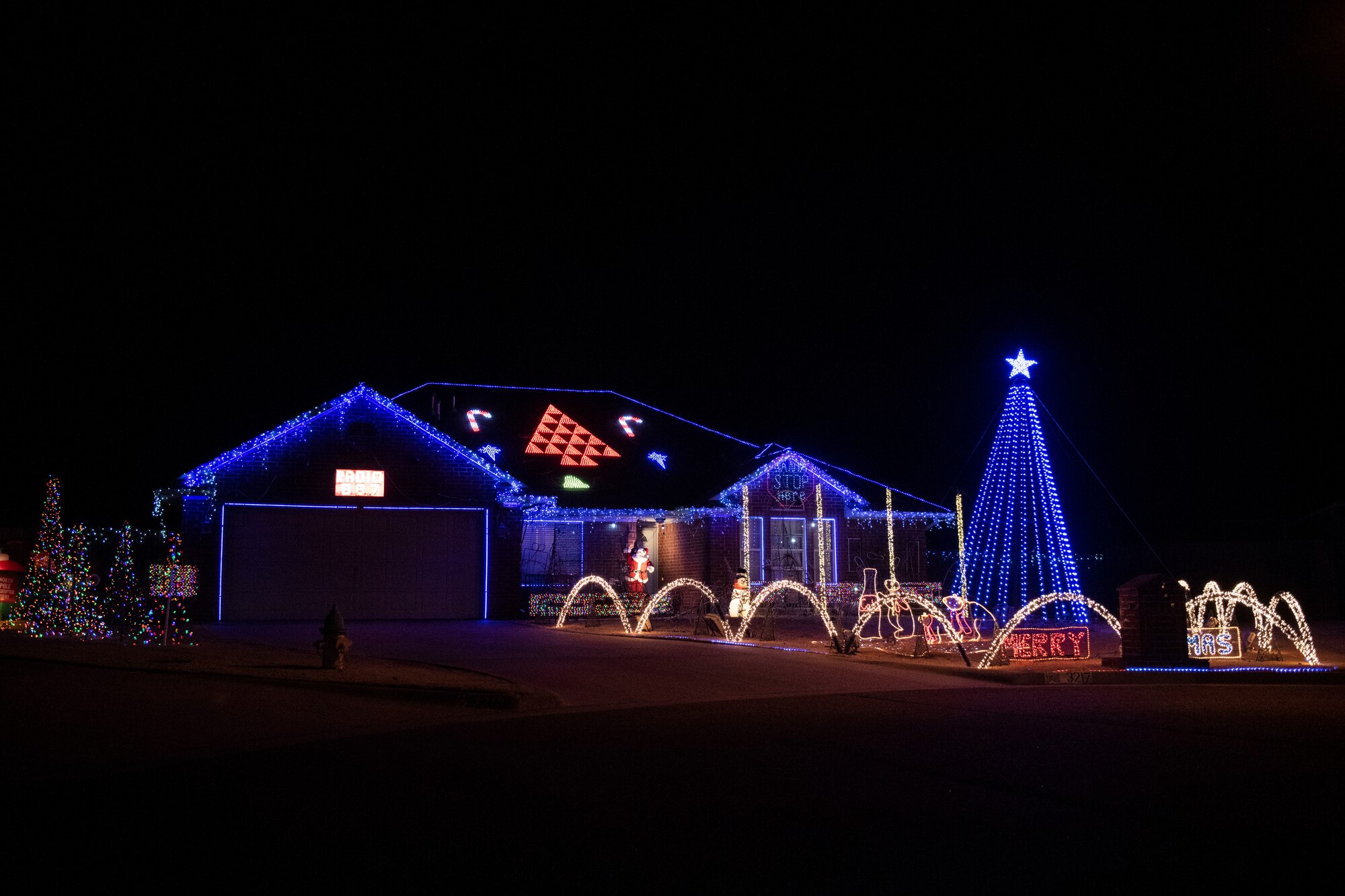Military family displays holiday lights.