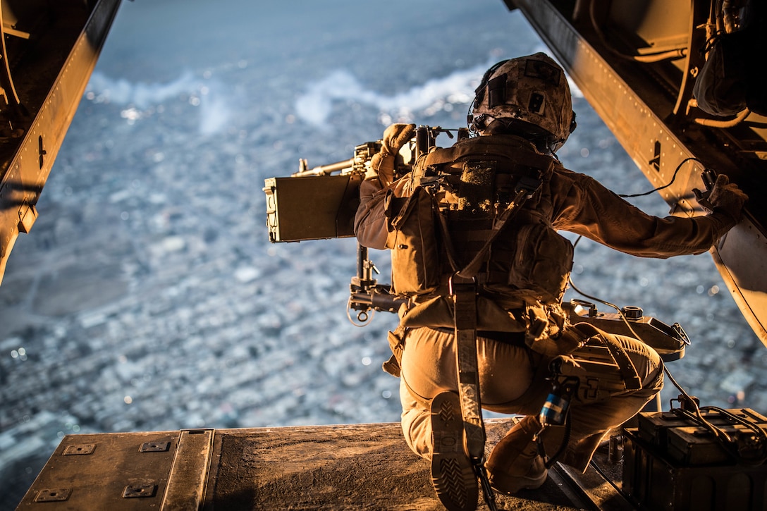 A U.S. Marine crew chief with Marine Medium Tiltrotor (VMM) 161 attached to Special Purpose Marine Air Ground Task Force-Crisis Response-Central Command 19.2 scans the horizon for enemy threats in an undisclosed location, Nov. 25, 2019. The SPMAGTF-CR-CC is a quick reaction force, prepared to deploy a variety of capabilities across the region.