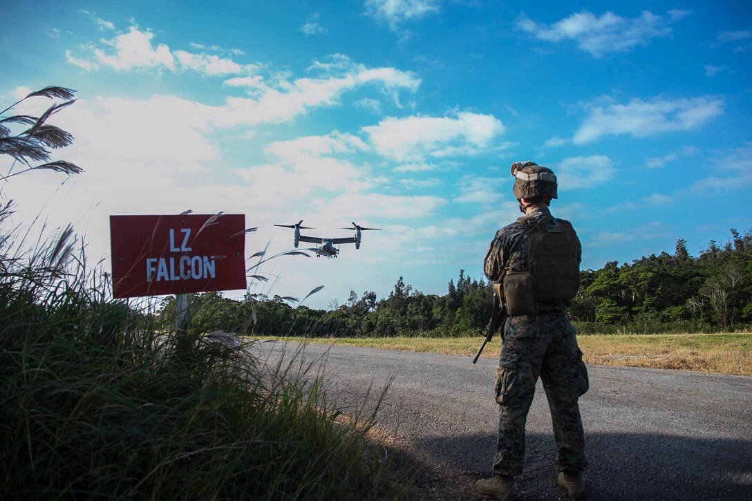 Capt. George McArthur, the Headquarters Company Commander for the 31st Marine Expeditionary Unit Command Element, observes an MV-22B Tiltrotor aircraft land before a conditioning hike in the Central Training Area, Okinawa, Japan, Nov 27, 2019. More than 150 Marines and Sailors Flew to a landing zone six miles away, marching back with a sustainment load, personal protective equipment, and weapons in preparation for an upcoming deployment. The 31st MEU, the Marine Corps' only continuously forward-deployed MEU, provides a flexible and lethal force ready to perform a wide range of military operations as the premier crisis response force in the Indo-Pacific region.