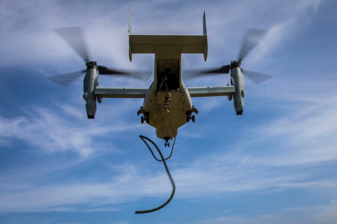 A U.S. Marine with 2nd Battalion, 3d Marine Regiment, fast ropes from a MV-22B Osprey assigned to Marine Medium Tiltrotor Squadron 363 during fast roping drills, Marine Corps Base Hawaii, Nov. 26, 2019. The training was designed to produce readiness by building confidence, familiarize the Marines with air assets, and prepare them for crisis response operations.