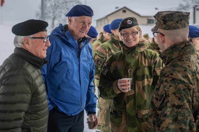 Norwegian Soldier and Norwegian Veterans talk to a U.S. Marine with Marine Rotational Force-Europe 20.1, Marine Forces Europe and Africa, during Veterans Memorial Day Ceremony in Bardufoss, Norway, Nov. 1, 2019. MRF-E focuses on regional engagements throughout Europe by conducting various exercises, arctic cold-weather and mountain-warfare training, and military-to-military engagements, which enhance overall interoperability of the U.S. Marine Corps with allies and partners.
