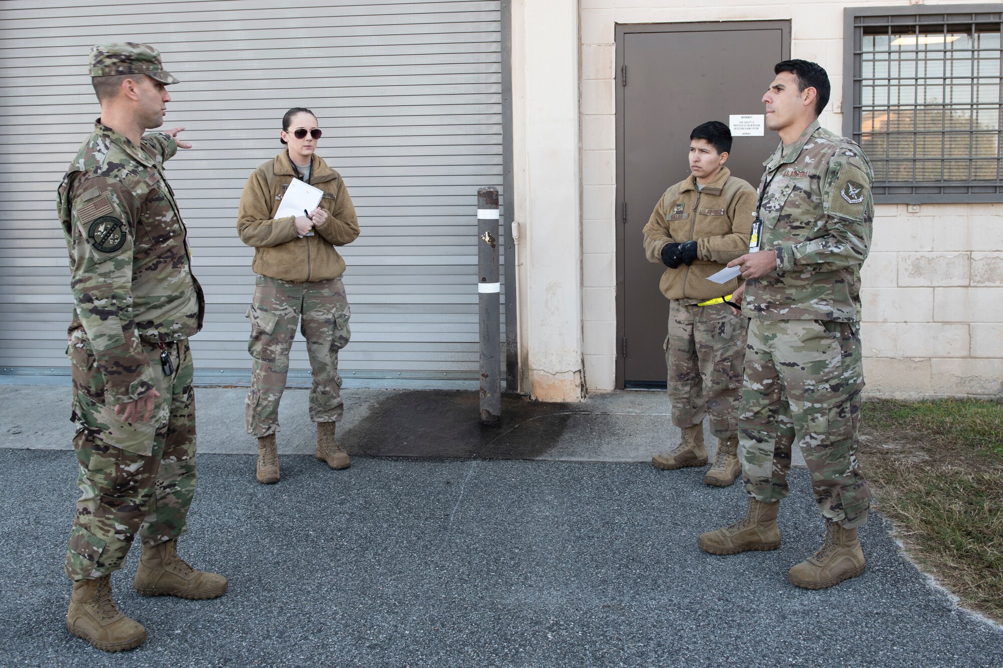 A photo of munitions Airmen going over procedures for an evacuation drill.