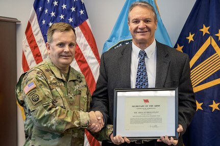 On behalf of Ryan D. McCarthy, Secretary of the U.S. Army, Brig. Gen. Mark S. Bennett, U.S. Army Financial Management Command commanding general, presents Greg Schmalfeldt, Defense Finance and Accounting Service Indianapolis director, with an Army Excellence in Financial Stewardship Award for Fiscal Year 2019 at the Maj. Gen. Emmett J. Bean Federal Center in Indianapolis Dec. 3, 2019. Immediately upon joining the Command Accountability and Execution Review program, the Army’s fiscal stewardship program that provides commanders with visibility of command fiscal health and holds leaders at every echelon responsible and accountable for stewardship of the tax dollars, Schmalfeldt demonstrated strong leadership, and his solutions provided to the program immediately reduced manual workload on transportation billing by 75 percent and freed up approximately $170 million in funding for use on other priorities. (U.S. Army photo by Mark R. W. Orders-Woempner)