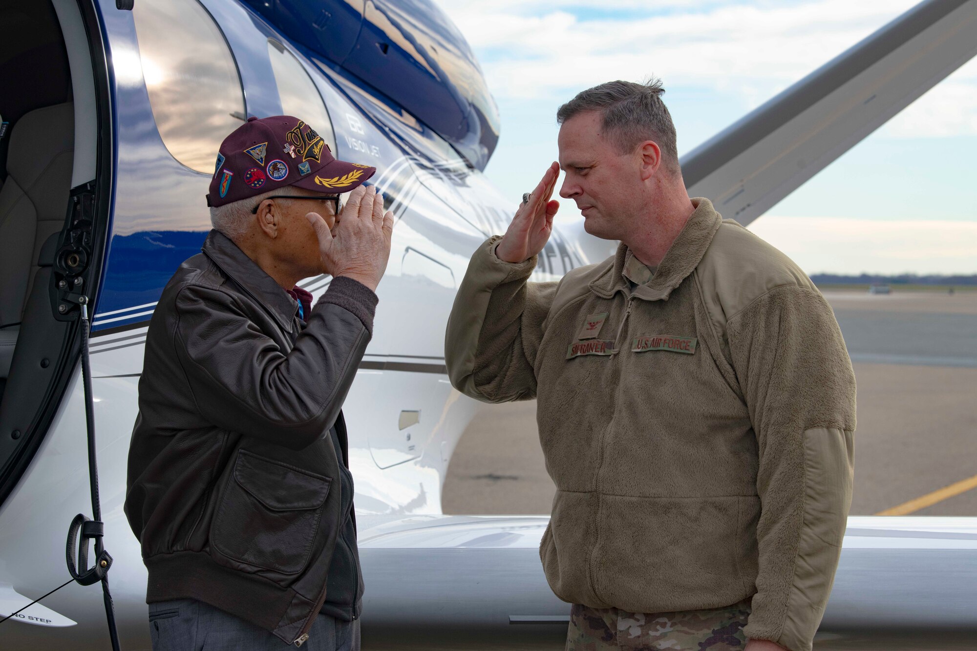 Former Tuskegee Airman, retired Col. Charles McGee, and 436th Airlift Wing commander Col. Joel Safranek exchange a salute during his visit Dec. 6, 2019, at Dover Air Force Base, Del. He served a total of 30 years in the U.S. Air Force, beginning with the U.S. Army Air Corps, and flew a total of 409 combat missions in World War II, Korea and Vietnam. The Tuskegee program began in 1941 when the 99th Pursuit Squadron was established, and its Airmen were the first ever African-American military aviators in the U.S. Army Air Corps. (U.S. Air Force photo by Senior Airman Christopher Quail)