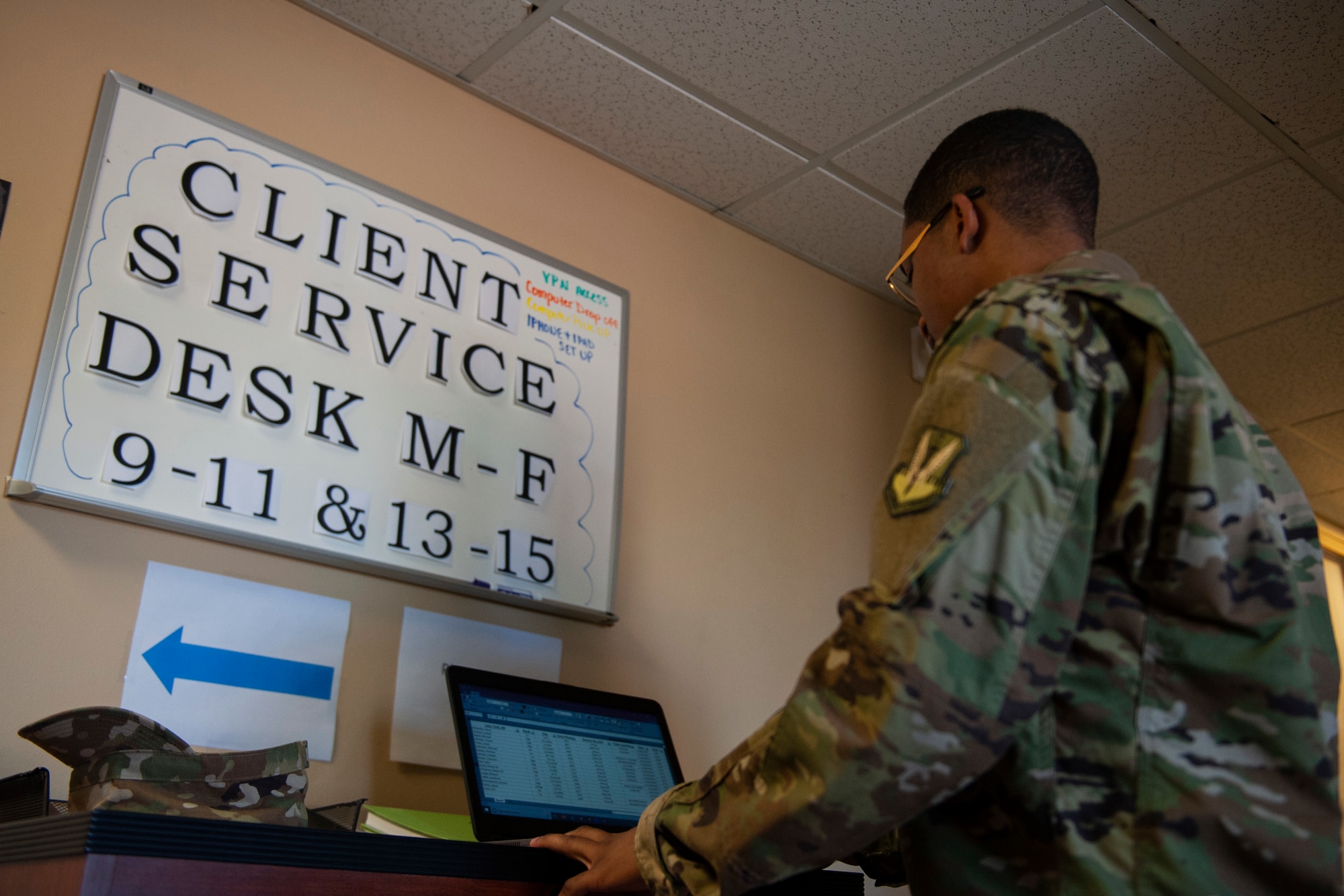 Photo of Airman checking a sign-in list