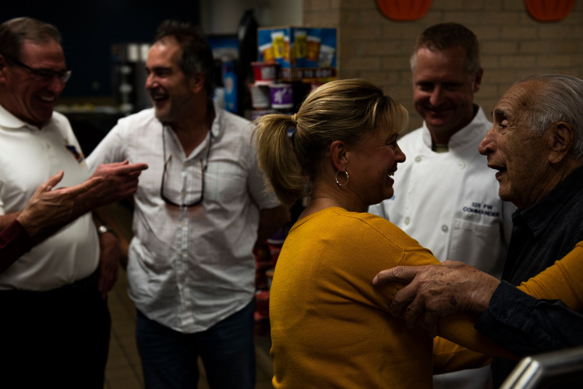 Samantha Laidlaw, left, greets Retired U.S. Air Force Lt. Col. Daniel Daube, right, at the 325th Force Support Squadron's holiday meal at Tyndall Air Force Base, Florida, Nov. 28, 2019. Attendees of the meal included service members, their spouses, dependents, and retirees. (U.S. Air Force photo by Staff Sgt. Magen M. Reeves)