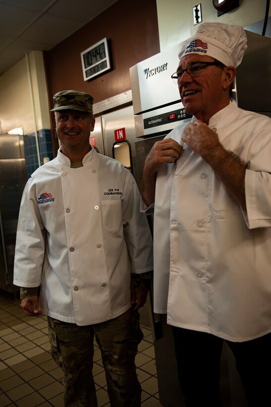 U.S. Air Force Col. Brian Laidlaw, 325th Fighter Wing commander, left, and Florida Congressman Neal Dunn, right, 
attend the 325th Force Support Squadron's holiday meal celebration at Tyndall Air Force Base, Florida, Nov. 28, 2019. Laidlaw and Dunn served food to service members, their spouses, dependents, and retirees to honor the service and sacrifice of military members past and present. (U.S. Air Force photo by Staff Sgt. Magen M. Reeves)
