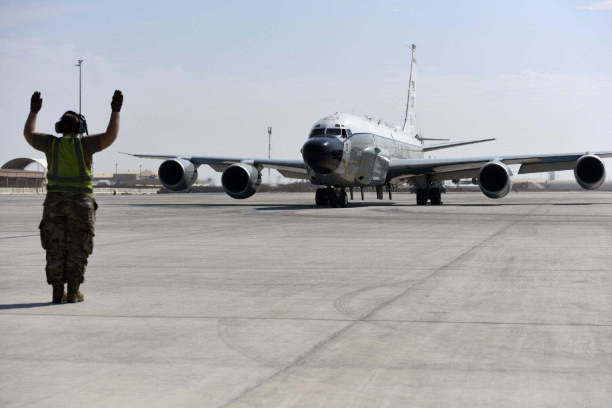 A crew chief assigned to the 763rd Expeditionary Reconnaissance Squadron directs a RC-135 Rivet Joint from its parking area in preparation for a mission at Al Udeid Air Base, Qatar on Nov. 21, 2019. The 763 ERS celebrated 29 years of Rivet Joint deployment in the U.S. Air Forces Central Command area of responsibility during a ceremony on Nov. 23.