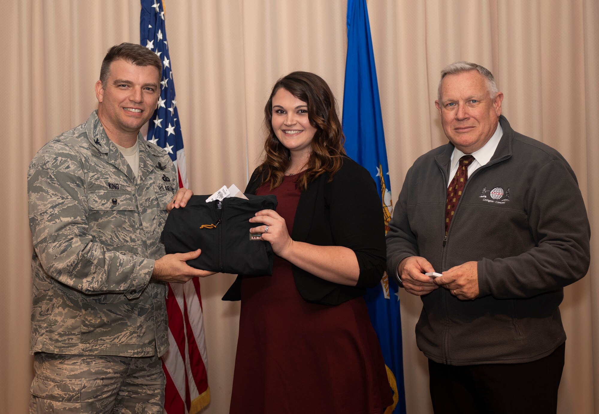 Col. Bobby King, Enterprise IT & Cyber Infrastructure Division senior materiel leader, and Patrick Marr, AFCEA Lexington-Concord Board of Directors chair, present Heather Collins, collaborative nerve center project lead for Command, Control, Communications, Intelligence and Networks Infrastructure Division, with a AFCEA Unsung Hero Awards ceremony at Hanscom Air Force Base, Mass., Dec. 5. Program Executive Offices and the 66th Air Base Group submitted seven unsung heroes who made significant contributions to their organization in 2019. Other award winners were April Mills, Nuclear Weapons Center Integration Directorate; Kathy O’Connor, Program Executive Offices Digital Directorate; Carolyn McCafferty, 66th Air Base Group; Michele Cimino, Booz Allen Hamilton; and Kevin MacDonald, Operational Contracting. (U.S. Air Force photo by Lauren Russell)