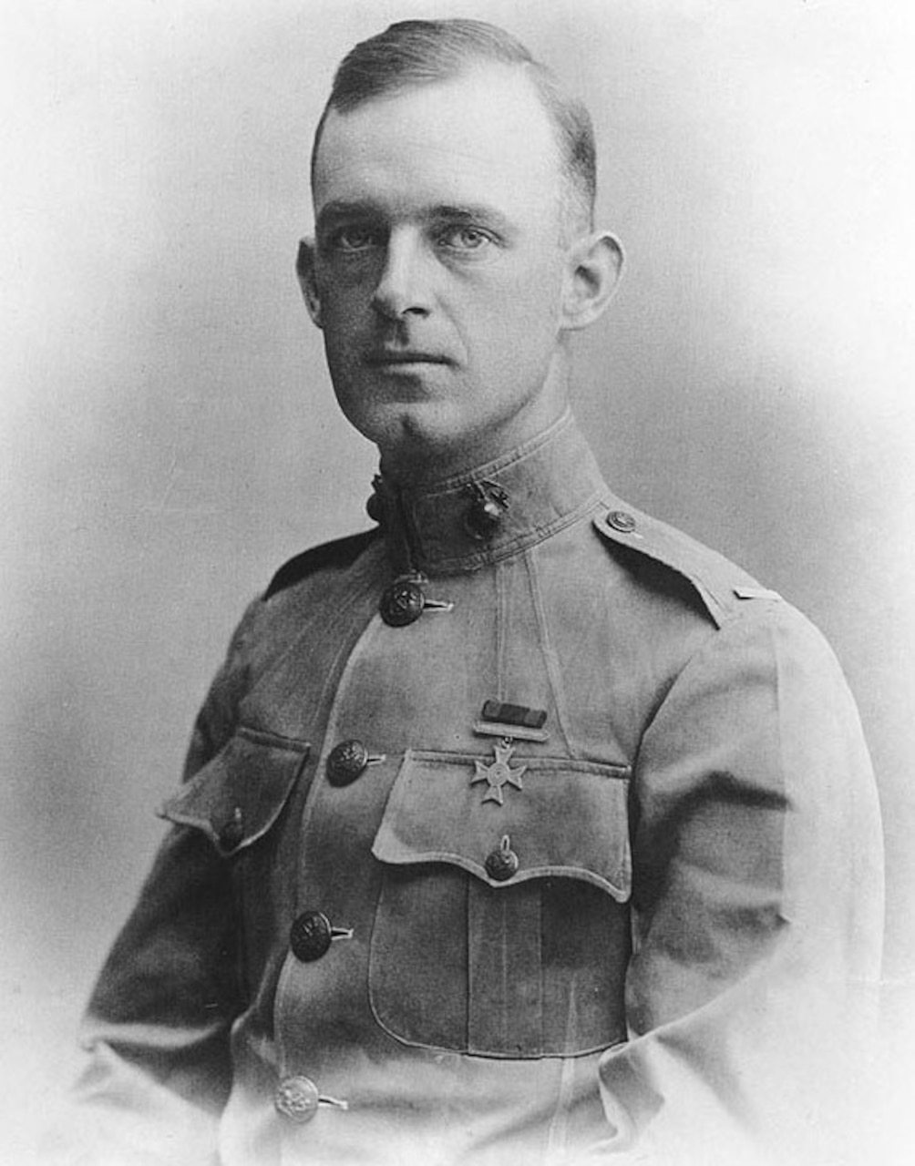 An early 1900s official photo of a Marine officer in dress uniform.