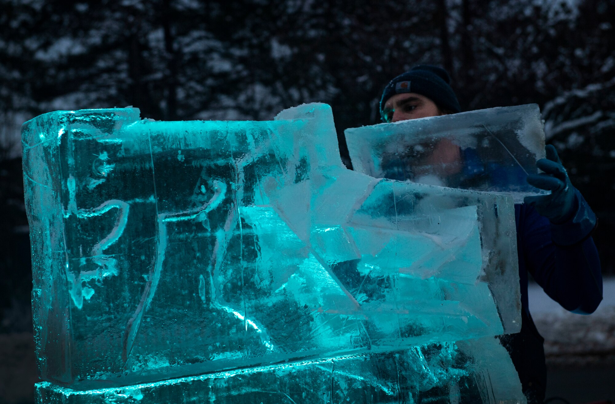 Lars Miller, an ice sculpter, carves a reindeer out of ice during the 2019 base tree lighting ceremony on Hanscom Air Force Base, Mass., Dec. 4. The ceremony included holiday carols sung by the Hanscom Middle School select choir and hot chocolate. (U.S. Air Force photo by Lauren Russell)