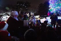 Lt. Col. Charles Silvanic, 66th Air Base Group and installation vice commander, Santa Claus, and base children, switch on the lights of the holiday tree during the 2019 tree lighting ceremony on Hanscom Air Force Base, Mass., Dec. 4. The annual event featured holiday carols by the Hanscom Middle School select choir, hot chocolate and cookies, and an ice sculpture display. (U.S. Air Force photo by Lauren Russell)
