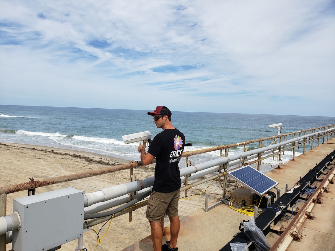 Nicholas Spore, a research civil engineer with the U.S. Army Engineer Research and Development Center’s Coastal and Hydraulics Laboratory’s Field Research Facility, positions equipment along a pier in Duck, North Carolina, Sept. 4, 2019, as part of the During Nearshore Event Experiment pilot study now underway along the Outer Banks. DUNEX is a multi-agency, academic and non-governmental organization collaborative community experiment to study nearshore coastal processes during coastal storms.