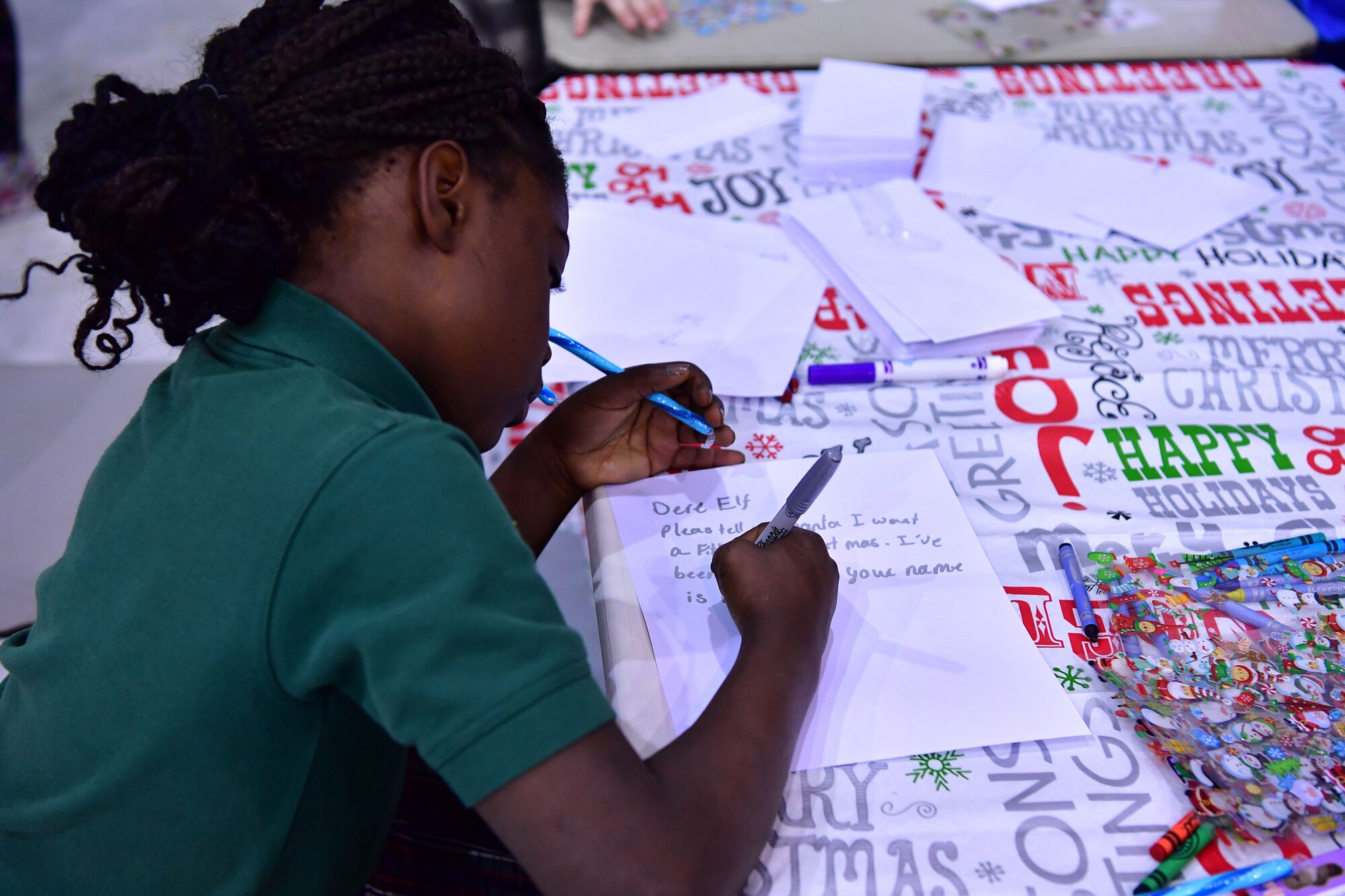 Children make cards for an Elf to deliver to Santa.