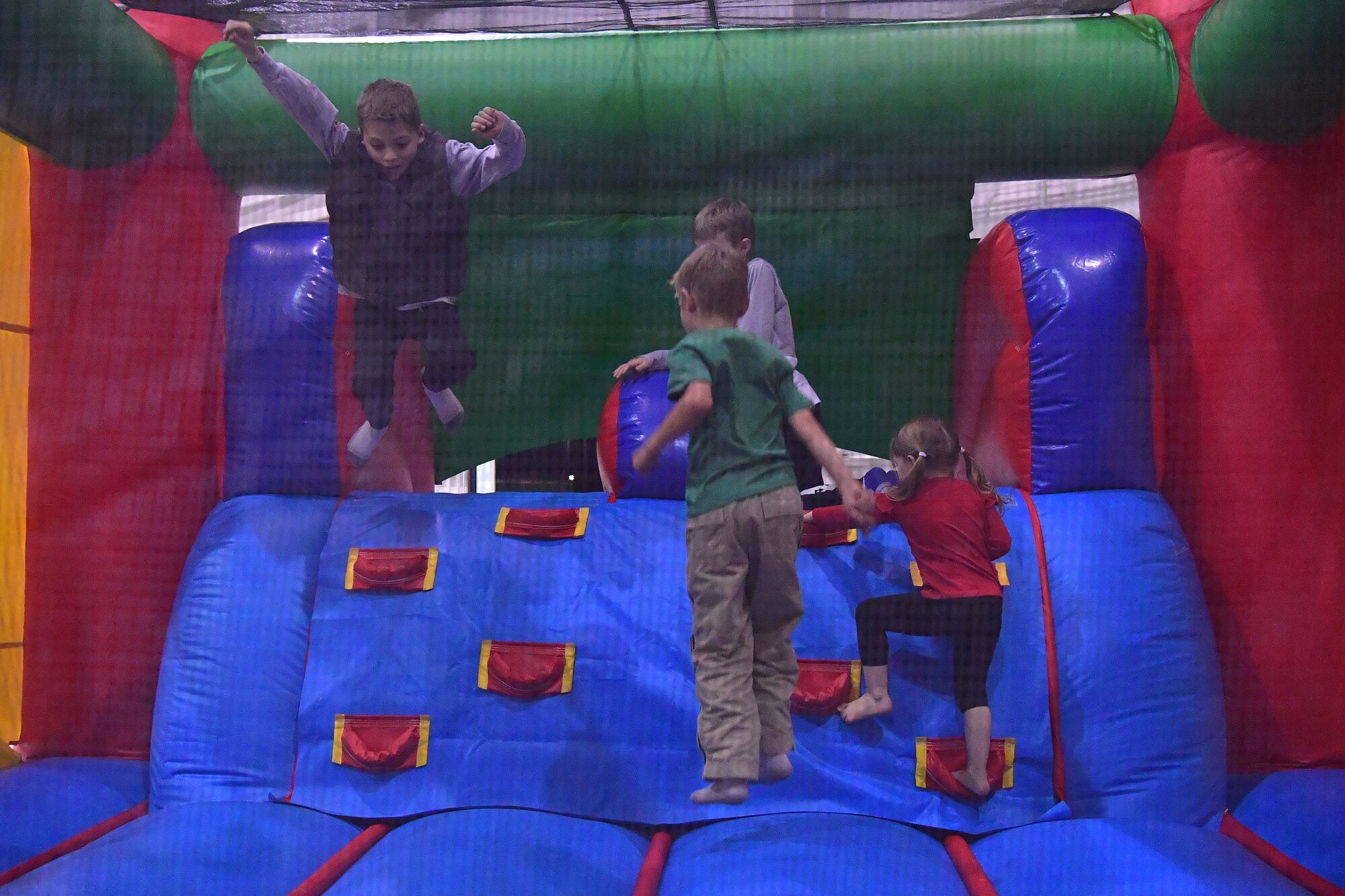 Children play in a bouncy house during the Red-Nosed Herk holiday celebration.