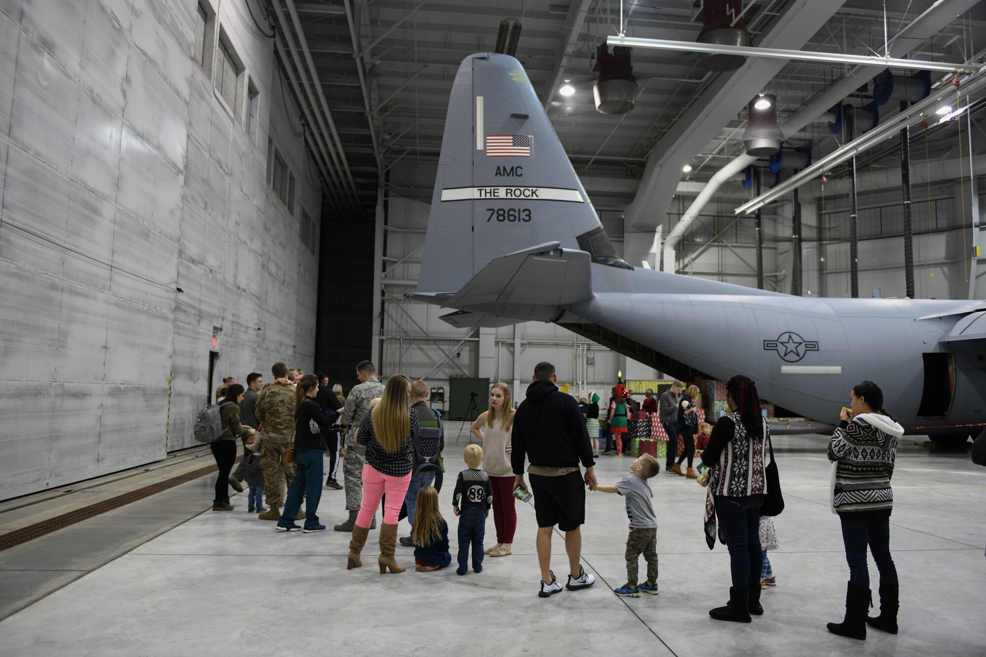 Airmen and families wait in line to take photos with Santa.