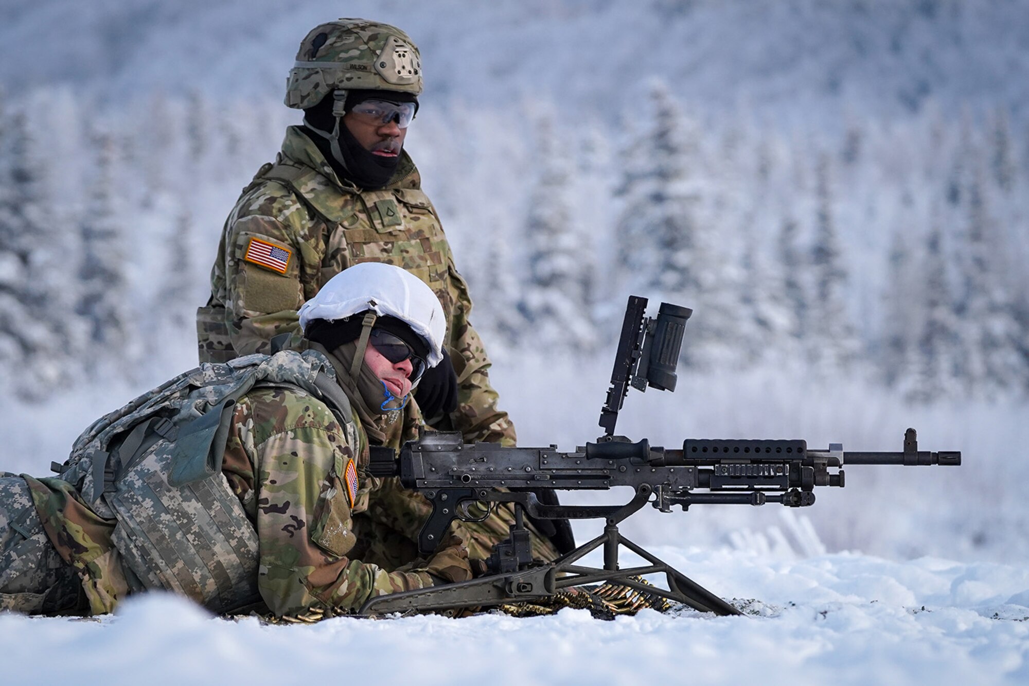 Paratroopers assigned to the 2nd Battalion, 377th Parachute Field Artillery Regiment, 4th Infantry Brigade Combat Team (Airborne), 25th Infantry Division, U.S. Army Alaska, wit for the order to load an M240B machine gun while conducting live-fire qualification at Grezelka range, on Joint Base Elmendorf-Richardson, Alaska, Dec. 5, 2019. The Soldiers practiced identifying, and engaging targets at varying distances to solidify their proficiency with the weapons in sub-arctic conditions.