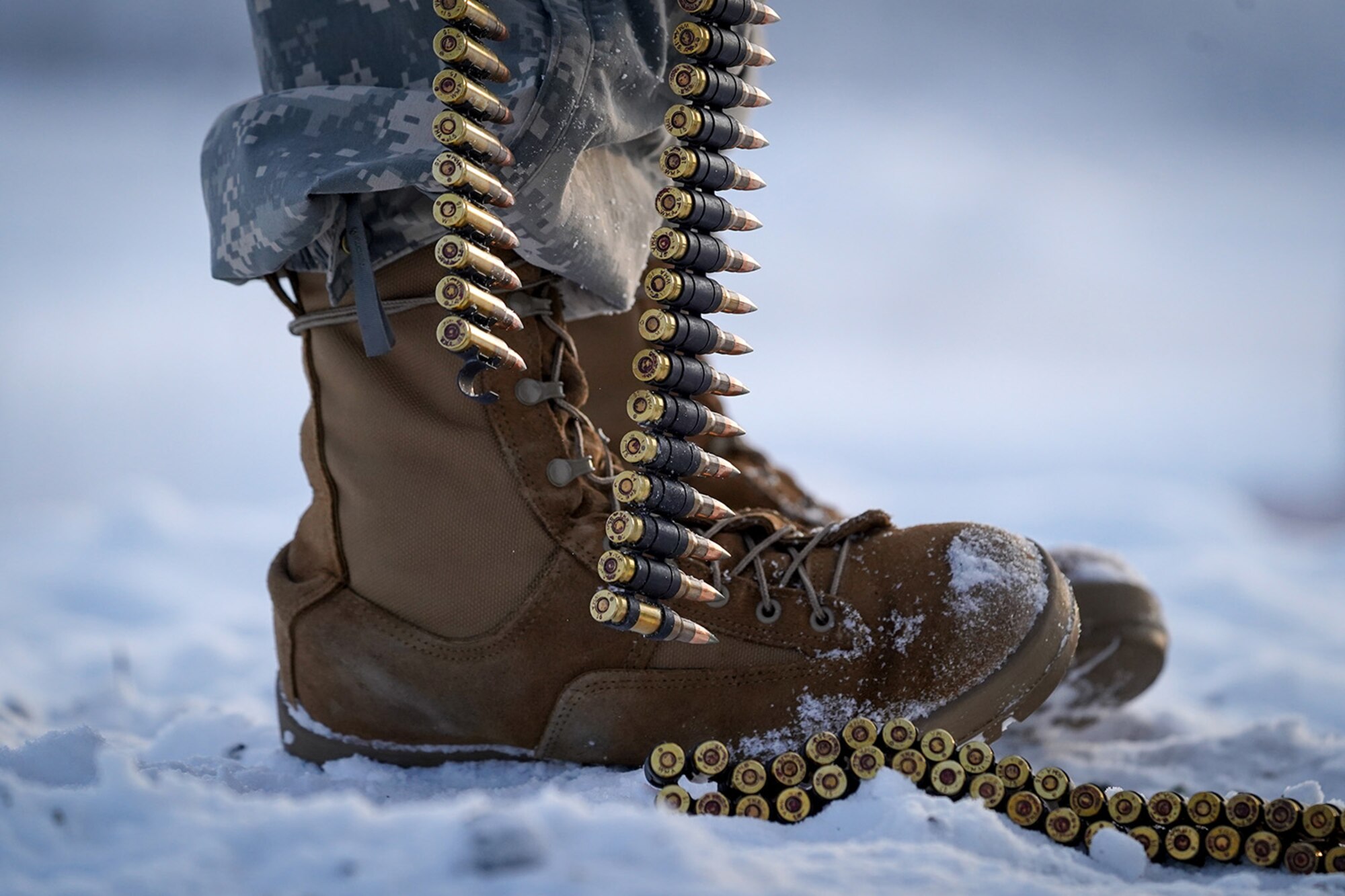 A paratrooper assigned to the 2nd Battalion, 377th Parachute Field Artillery Regiment, 4th Infantry Brigade Combat Team (Airborne), 25th Infantry Division, U.S. Army Alaska, holds a linked belt of 7.62mm ammunition while waiting to conduct live-fire qualification at Grezelka range, on Joint Base Elmendorf-Richardson, Alaska, Dec. 5, 2019. The Soldiers practiced identifying, and engaging targets at varying distances to solidify their proficiency with the weapons in sub-arctic conditions.