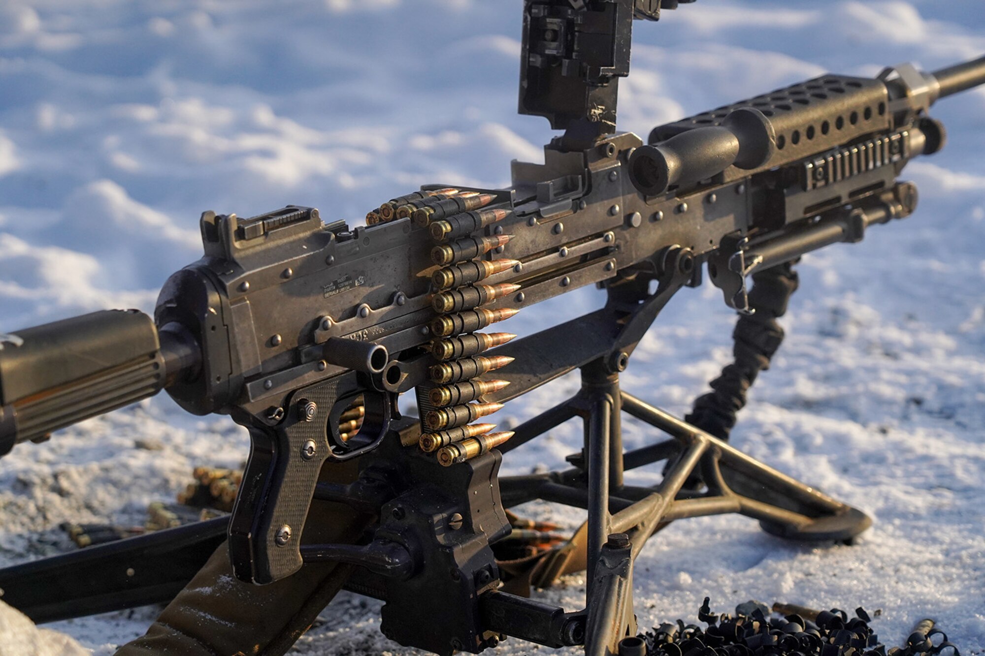 A linked belt of 7.62mm ammunition is seen draping over an M240B machine gun as paratroopers assigned to the 2nd Battalion, 377th Parachute Field Artillery Regiment, 4th Infantry Brigade Combat Team (Airborne), 25th Infantry Division, U.S. Army Alaska, conduct live-fire qualification at Grezelka range, on Joint Base Elmendorf-Richardson, Alaska, Dec. 5, 2019. The Soldiers practiced identifying, and engaging targets at varying distances to solidify their proficiency with the weapons in sub-arctic conditions.