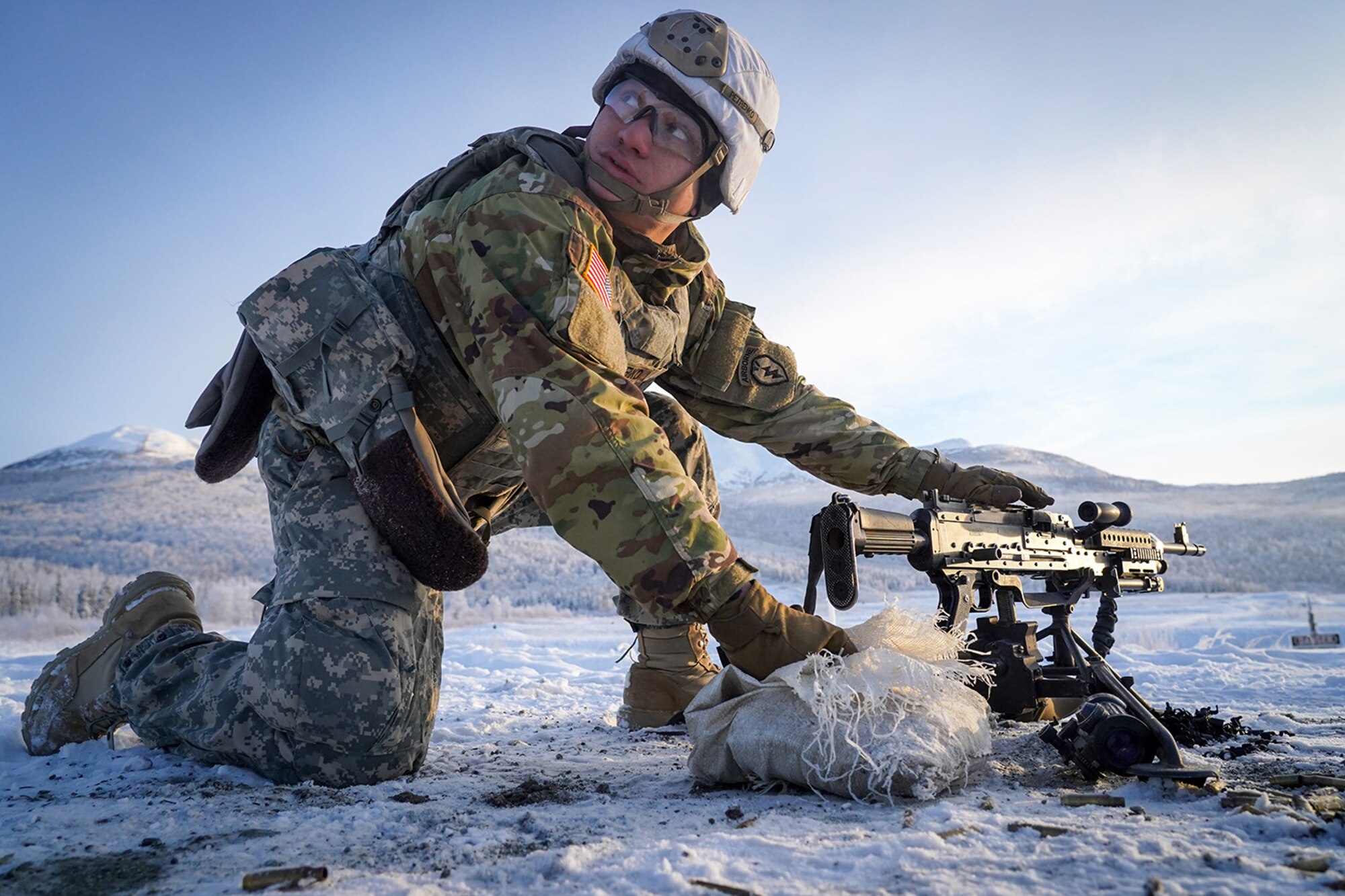 Army Pfc. John Paul Petrenko, a native of Jamaica, N.Y., assigned to the 2nd Battalion, 377th Parachute Field Artillery Regiment, 4th Infantry Brigade Combat Team (Airborne), 25th Infantry Division, U.S. Army Alaska, listens for the order to load an M240B machine gun while conducting live-fire qualification at Grezelka range, on Joint Base Elmendorf-Richardson, Alaska, Dec. 5, 2019. The Soldiers practiced identifying, and engaging targets at varying distances to solidify their proficiency with the weapons in sub-arctic conditions.