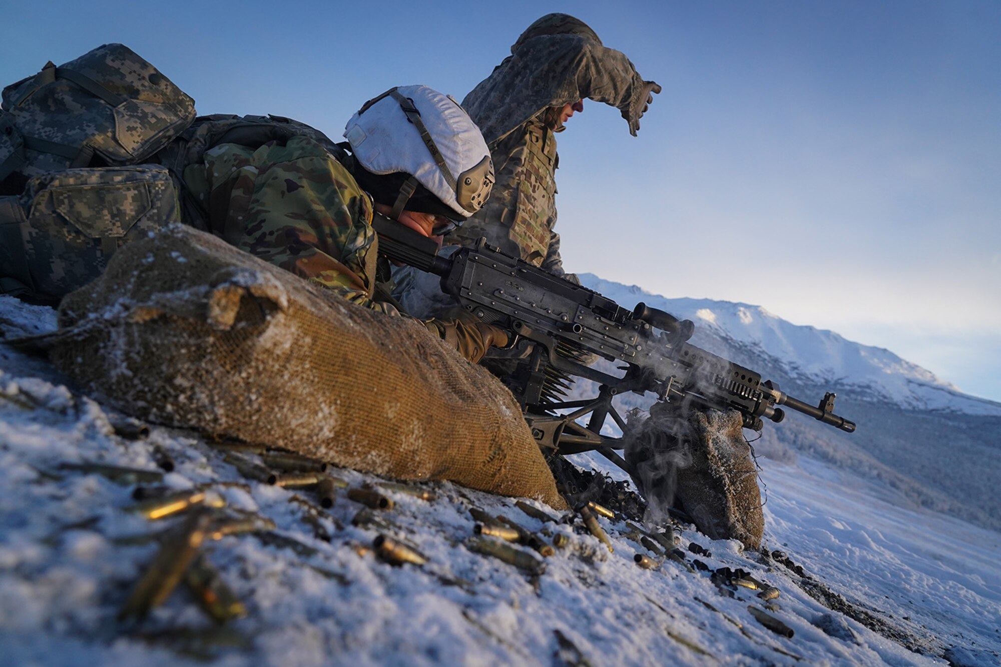 Army Pfc. John Paul Petrenko, a native of Jamaica, N.Y., fires an M240B machine gun as his assistant gunner Army Pfc. Blade Briscoe, a native of Fort Drum, N.Y., spots targets while the Soldiers, both assigned to the 2nd Battalion, 377th Parachute Field Artillery Regiment, 4th Infantry Brigade Combat Team (Airborne), 25th Infantry Division, U.S. Army Alaska, conduct live-fire qualification at Grezelka range, on Joint Base Elmendorf-Richardson, Alaska, Dec. 5, 2019. The Soldiers practiced identifying, and engaging targets at varying distances to solidify their proficiency with the weapons in sub-arctic conditions.