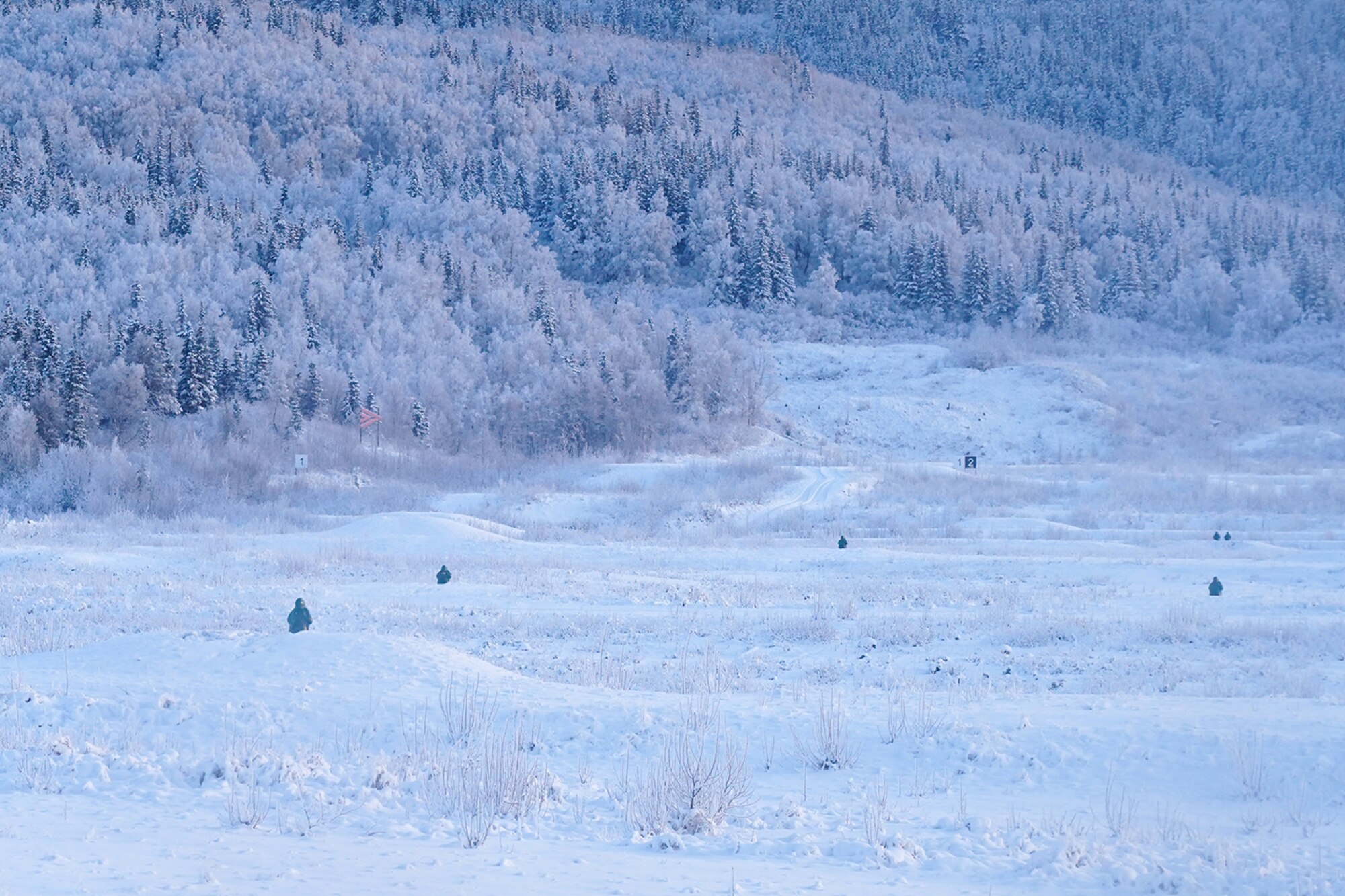 Targets are seen downrange in the waning afternoon light as paratroopers assigned to the 2nd Battalion, 377th Parachute Field Artillery Regiment, 4th Infantry Brigade Combat Team (Airborne), 25th Infantry Division, U.S. Army Alaska, use M240B, and M2 machine guns while conducting live-fire qualification at Grezelka range, on Joint Base Elmendorf-Richardson, Alaska, Dec. 5, 2019. The Soldiers practiced identifying, and engaging targets at varying distances to solidify their proficiency with the weapons in sub-arctic conditions.