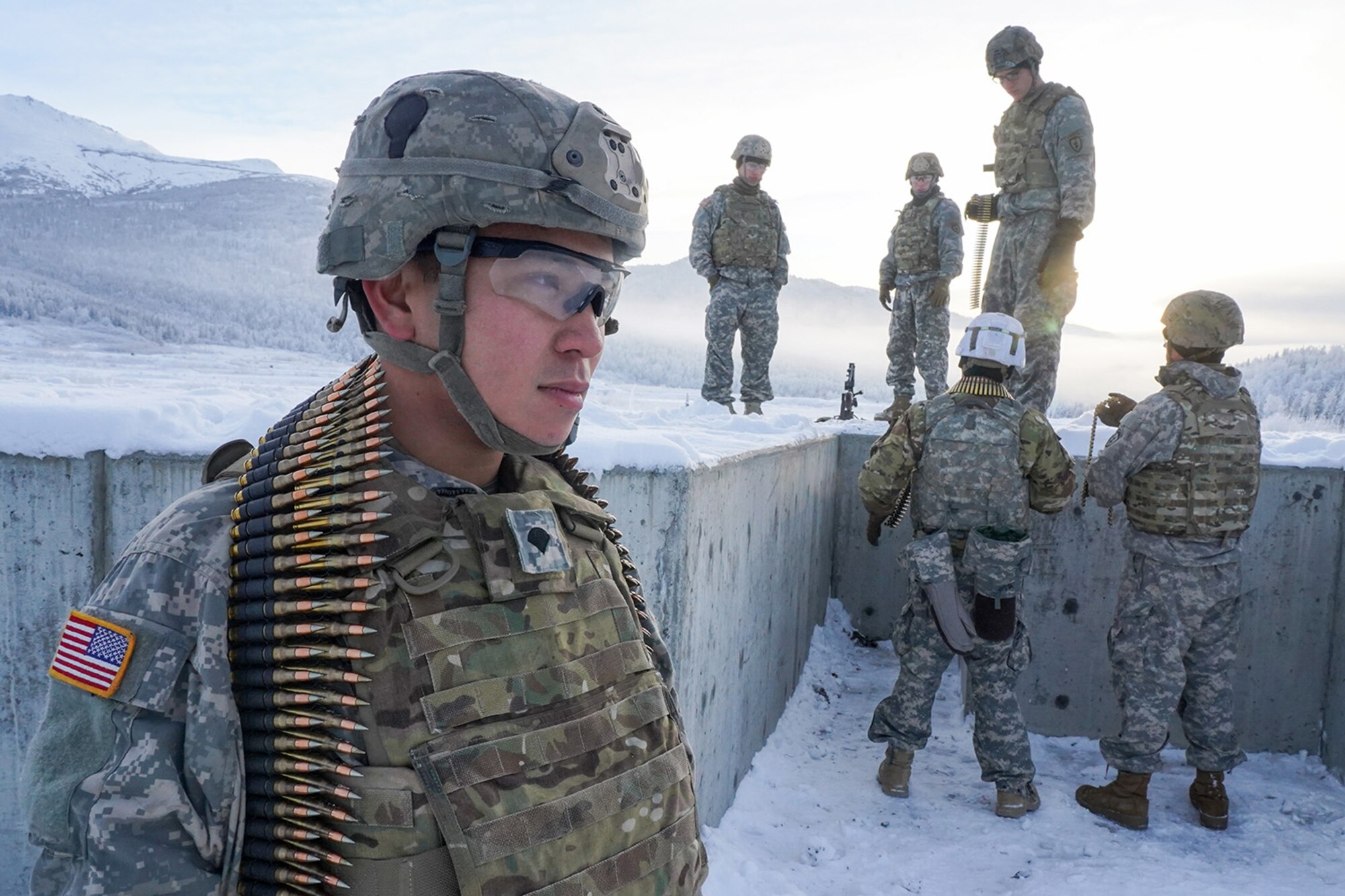 Spc. Ben Clarke, a native of Doylestown, Pa., assigned to the 2nd Battalion, 377th Parachute Field Artillery Regiment, 4th Infantry Brigade Combat Team (Airborne), 25th Infantry Division, U.S. Army Alaska, waits for his turn to fire an M240B machine gun while conducting live-fire qualification at Grezelka range, on Joint Base Elmendorf-Richardson, Alaska, Dec. 5, 2019. The Soldiers practiced identifying, and engaging targets at varying distances to solidify their proficiency with the weapons in sub-arctic conditions.