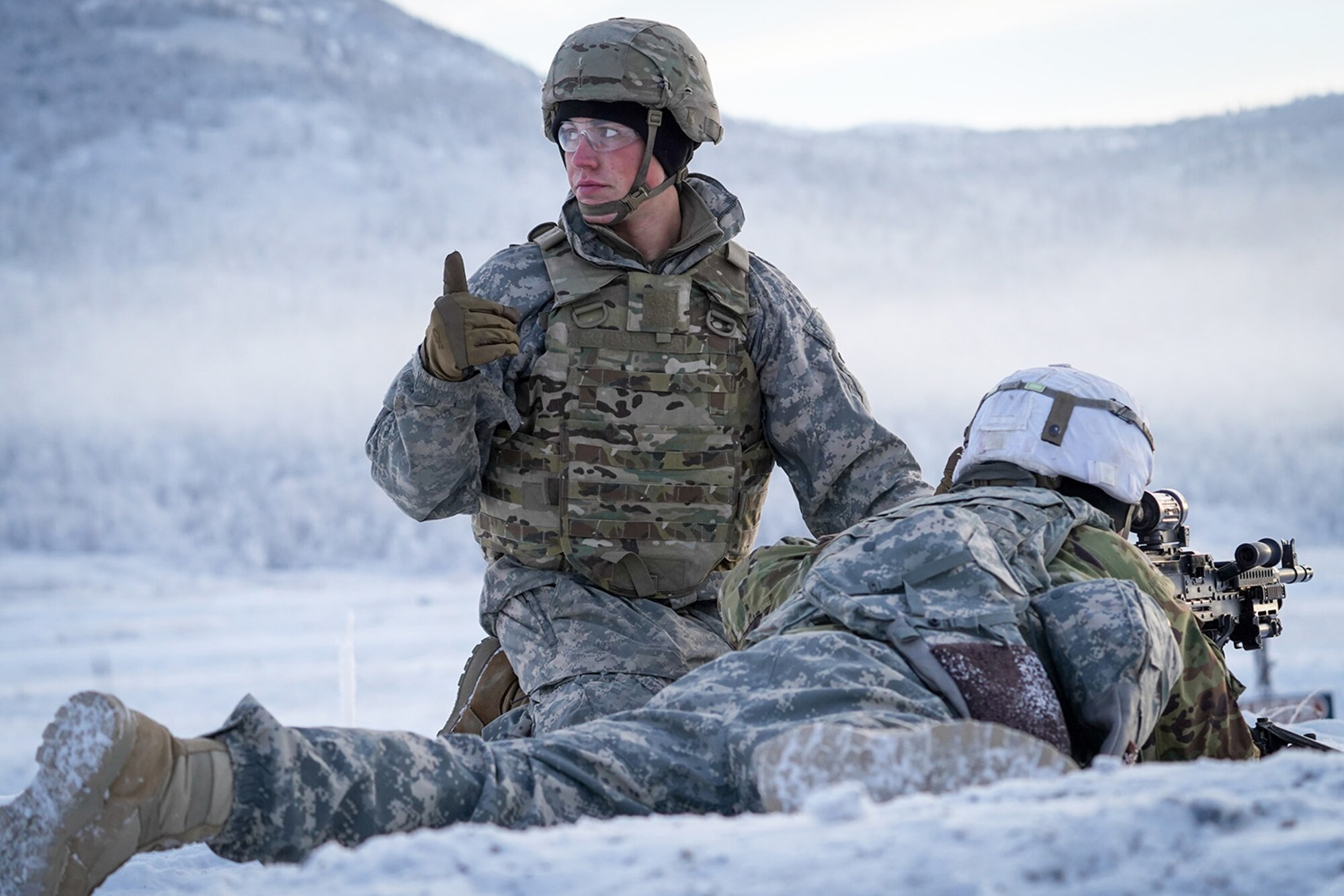 Army Pfc. Blade Briscoe, a native of Fort Drum, N.Y., assigned to the 2nd Battalion, 377th Parachute Field Artillery Regiment, 4th Infantry Brigade Combat Team (Airborne), 25th Infantry Division, U.S. Army Alaska, signals his lane is ready to fire while conducting live-fire qualification at Grezelka range, on Joint Base Elmendorf-Richardson, Alaska, Dec. 5, 2019. The Soldiers practiced identifying, and engaging targets at varying distances to solidify their proficiency with the weapons in sub-arctic conditions.