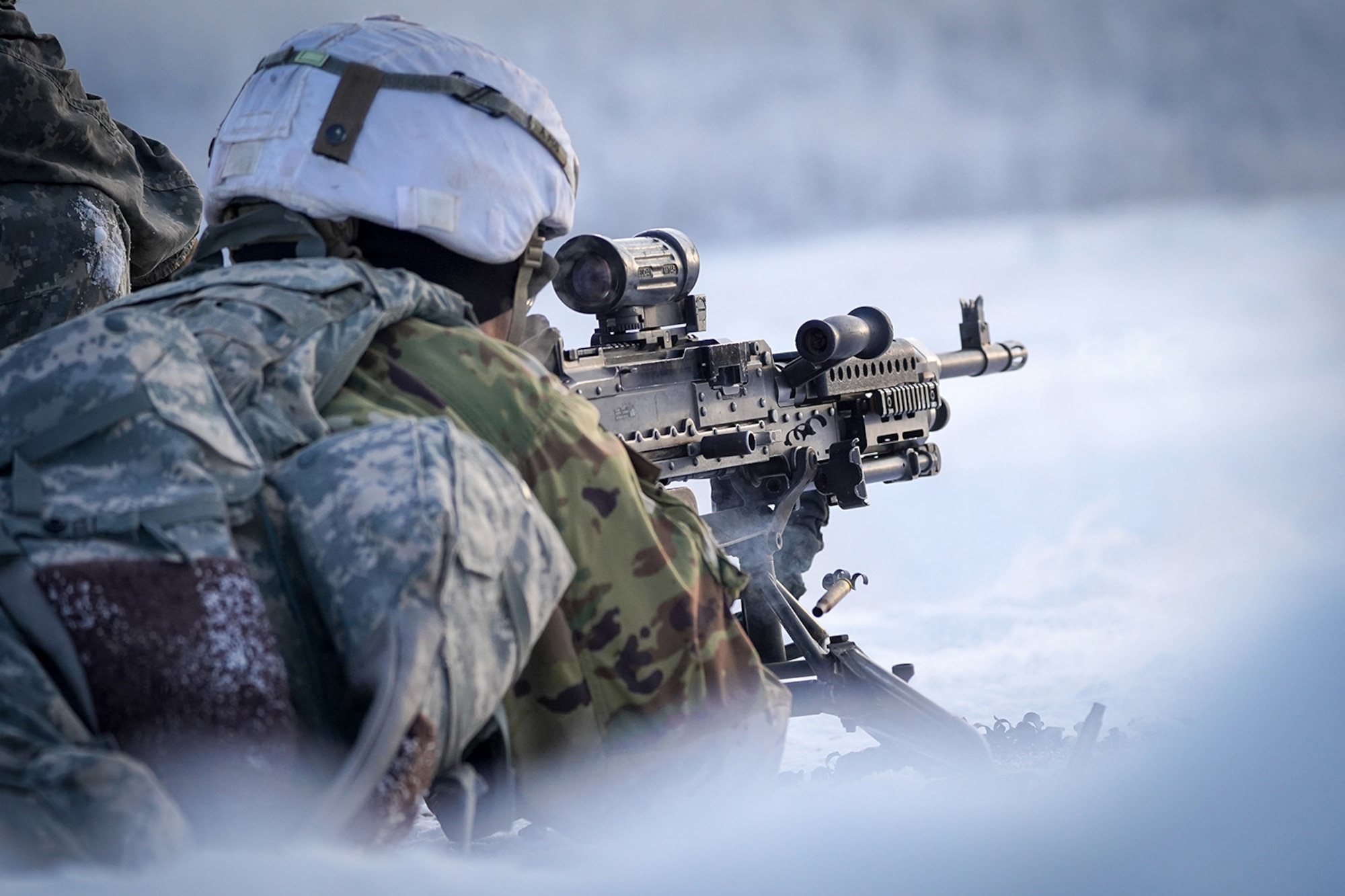 A paratrooper assigned to the 2nd Battalion, 377th Parachute Field Artillery Regiment, 4th Infantry Brigade Combat Team (Airborne), 25th Infantry Division, U.S. Army Alaska, fires an M240B machine gun while conducting live-fire qualification at Grezelka range, on Joint Base Elmendorf-Richardson, Alaska, Dec. 5, 2019. The Soldiers practiced identifying, and engaging targets at varying distances to solidify their proficiency with the weapons in sub-arctic conditions.