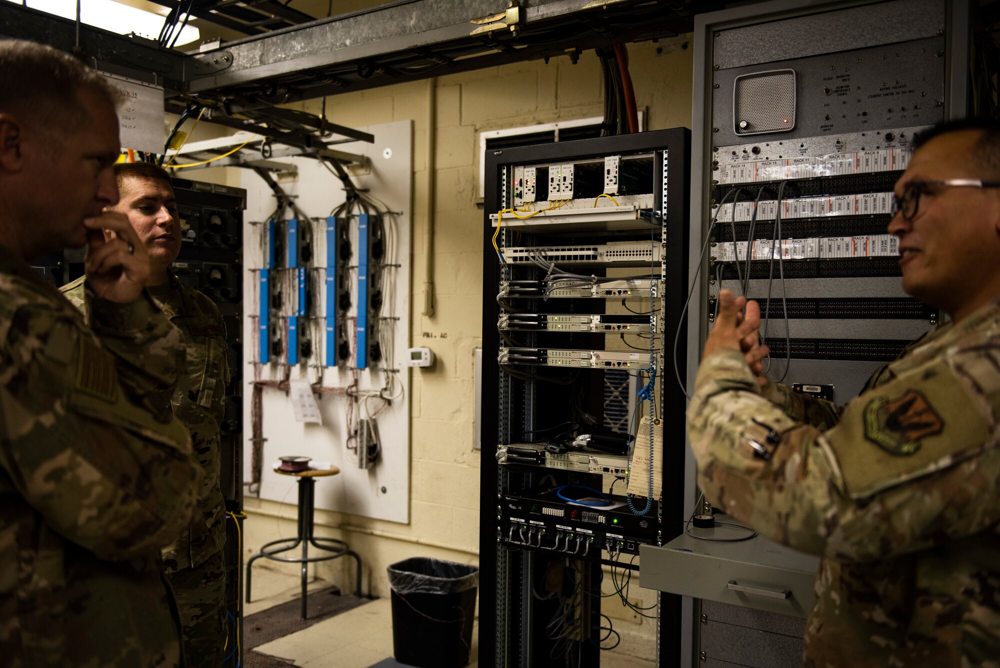 U.S. Air Force Col. Brian Laidlaw, 325th Fighter Wing commander, left, talks to U.S. Air Force Staff Sgt. Christopher Kiebach, 325th Operations Support Squadron Radar, Airfield, and Weather Systems supervisor, canter, and U.S. Air Force Tech. Sgt. Richard Oliver 325th OSS RAWS noncommissioned officer in charge at Tyndall Air Force Base, Florida, Nov. 26, 2019. Kiebach and his team maintain air traffic and control systems for Tyndall including all means of communication from air traffic controllers to aircraft operators via radio, as well as interagency communication via telephones. The unit uses transmitter towers, located at vantage points across the base's flight line. (U.S. Air Force photo by Staff Sgt. Magen M. Reeves)