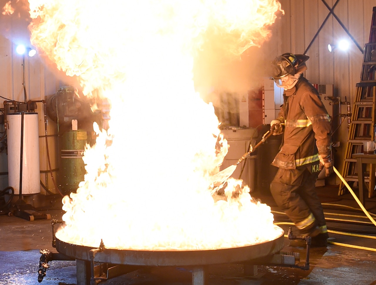 A person douses a  fire.