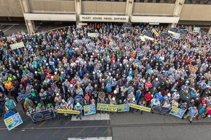 Employees from Puget Sound Naval Shipyard & Intermediate Maintenance Facility took part in an ‘Ohana tribute gathering to show support for Pearl Harbor Naval Shipyard, during a lunchtime event Friday, Dec. 6, in Bremerton, Washington. The event, which was attended by several thousand employees wearing aloha shirts, featured remarks from senior leaders, a moment of silence and a group photo.