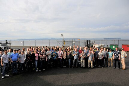 Employees from Puget Sound Naval Shipyard & Intermediate Maintenance Facility took part in an ‘Ohana tribute gathering to show support for Pearl Harbor Naval Shipyard, during a lunchtime event Friday, Dec. 6, in Bremerton, Washington. The event, which was attended by several thousand employees wearing aloha shirts, featured remarks from senior leaders, a moment of silence and a group photo.