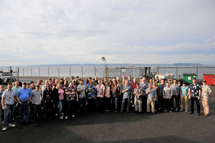 Employees from Puget Sound Naval Shipyard & Intermediate Maintenance Facility took part in an ‘Ohana tribute gathering to show support for Pearl Harbor Naval Shipyard, during a lunchtime event Friday, Dec. 6, in Bremerton, Washington. The event, which was attended by several thousand employees wearing aloha shirts, featured remarks from senior leaders, a moment of silence and a group photo.