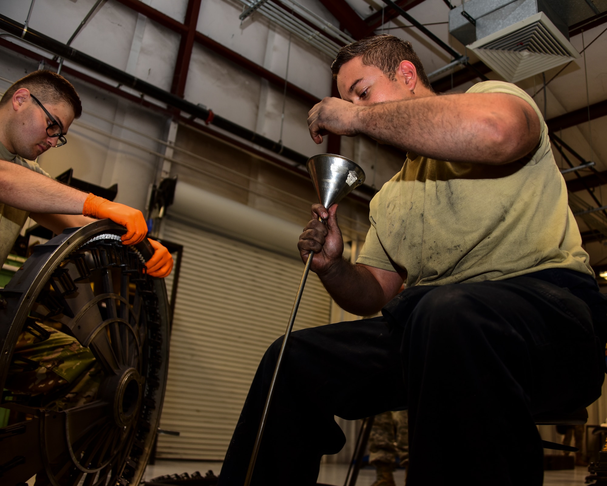 A photo of Airmen working on a Gatling gun