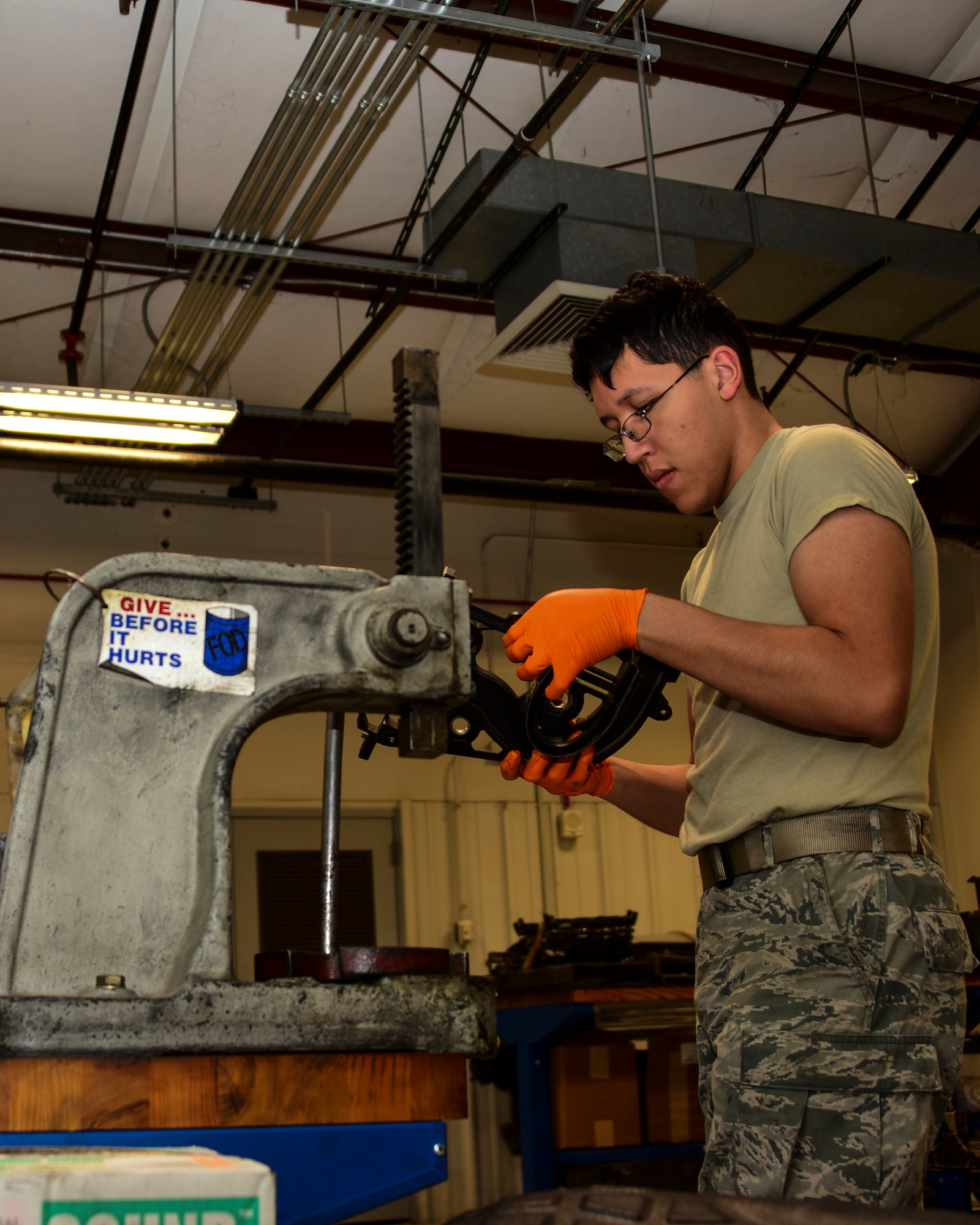 A photo of an Airman working on Gatling gun