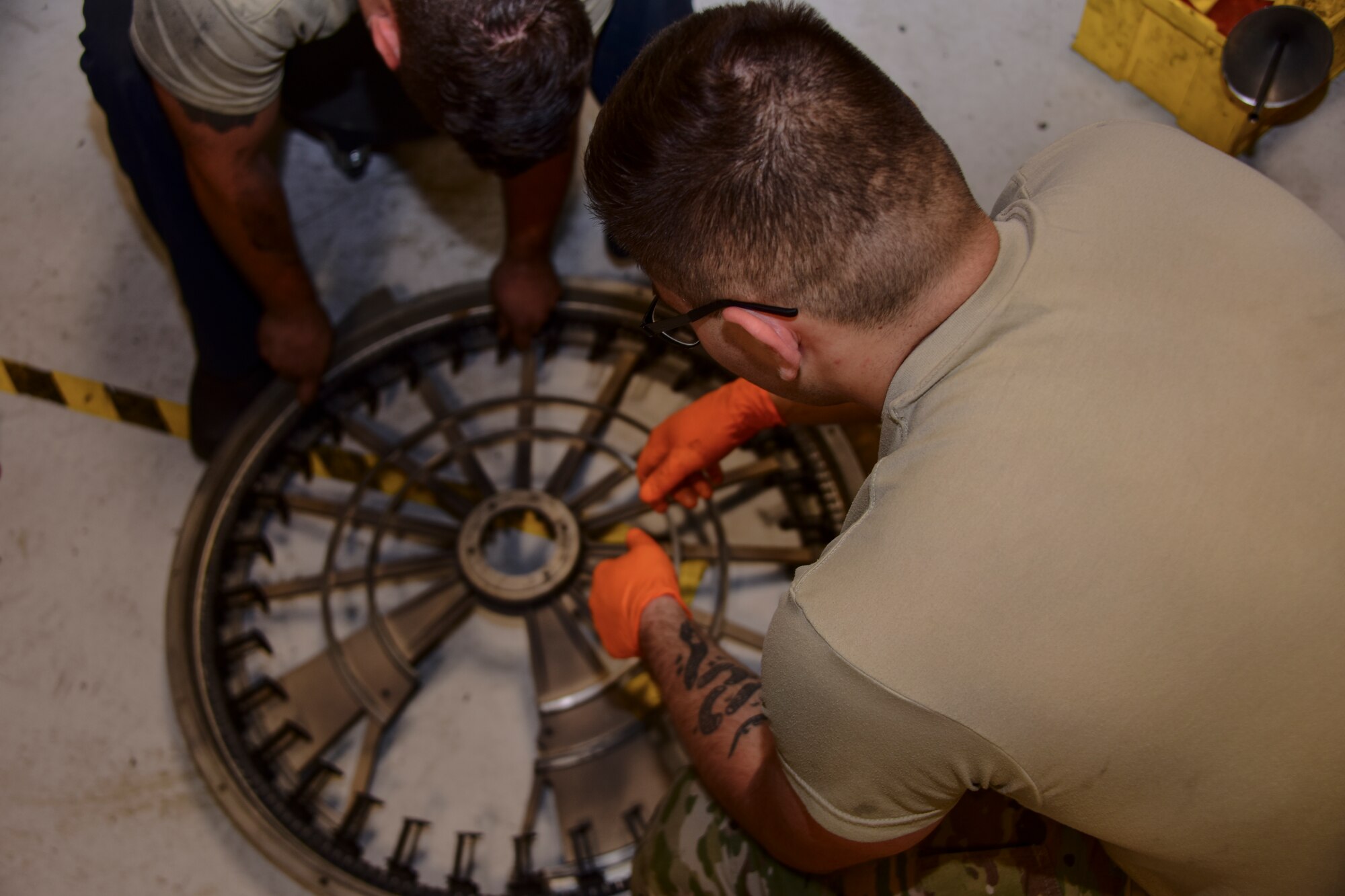 A photo of Airmen rebuilding a Gatling gun