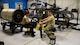 A photo of Airmen working on a Gatling gun