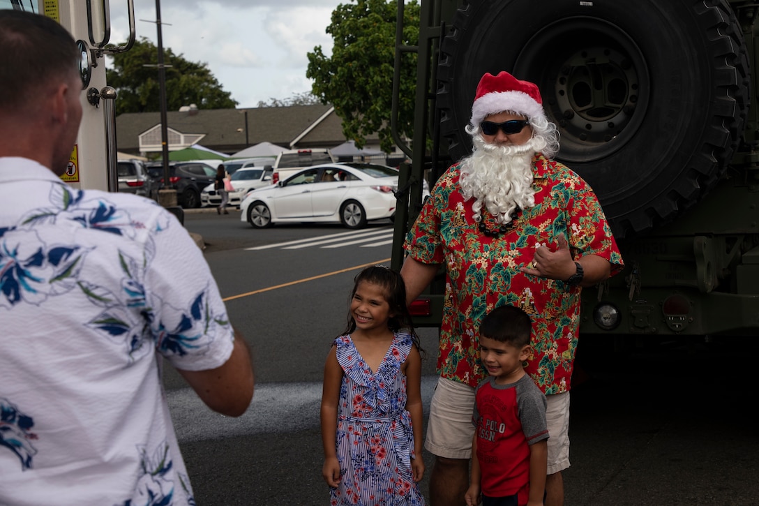 Children take a photo with Santa Claus during Santa's Village outside the Marine Corps Exchange, Marine Corps Base Hawaii, Nov. 30, 2019. Santa's Village was hosted by Marine Corps Community Services and served to bring holiday cheer and camaraderie to the families stationed on base. (U.S. Marine Corps photo by Sgt. Alex Kouns)