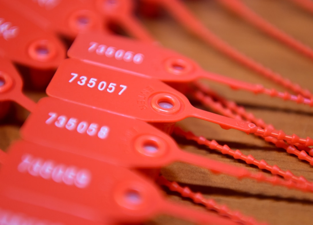 Seals for the communications kit rest in a pile at RAF Mildenhall, England, Dec. 3, 2019. Airmen from the 100th Operations Support Squadron combat crew communications office use these seals to ensure kits are secure and free from tampering. (U.S. Air Force photo Senior Airman Brandon Esau)