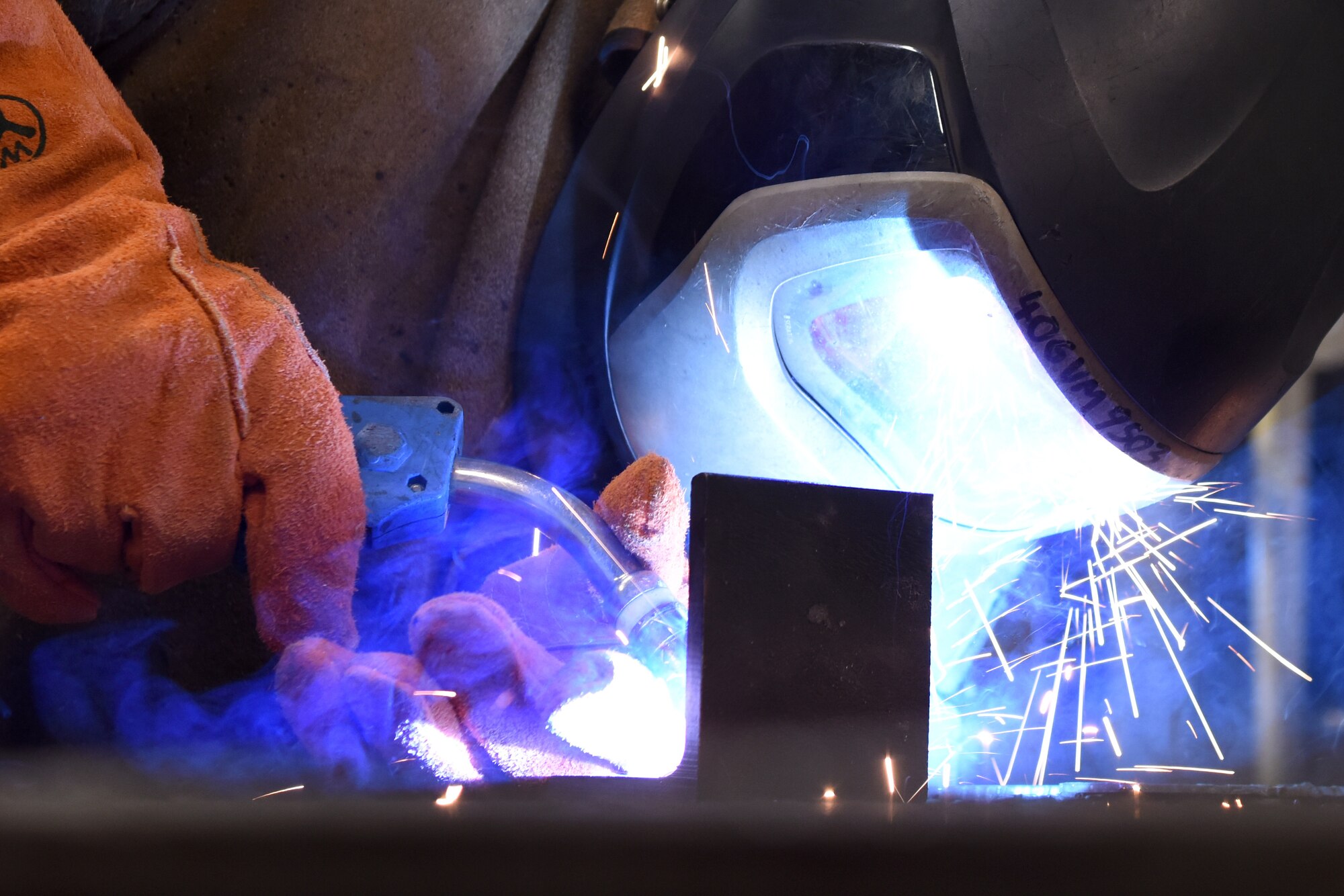 Auto body repair technician performs a metal inert gas weld