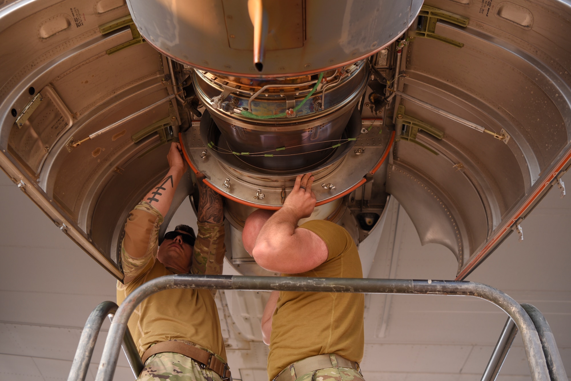 Airmen install new parts on a HC-130J Hercules