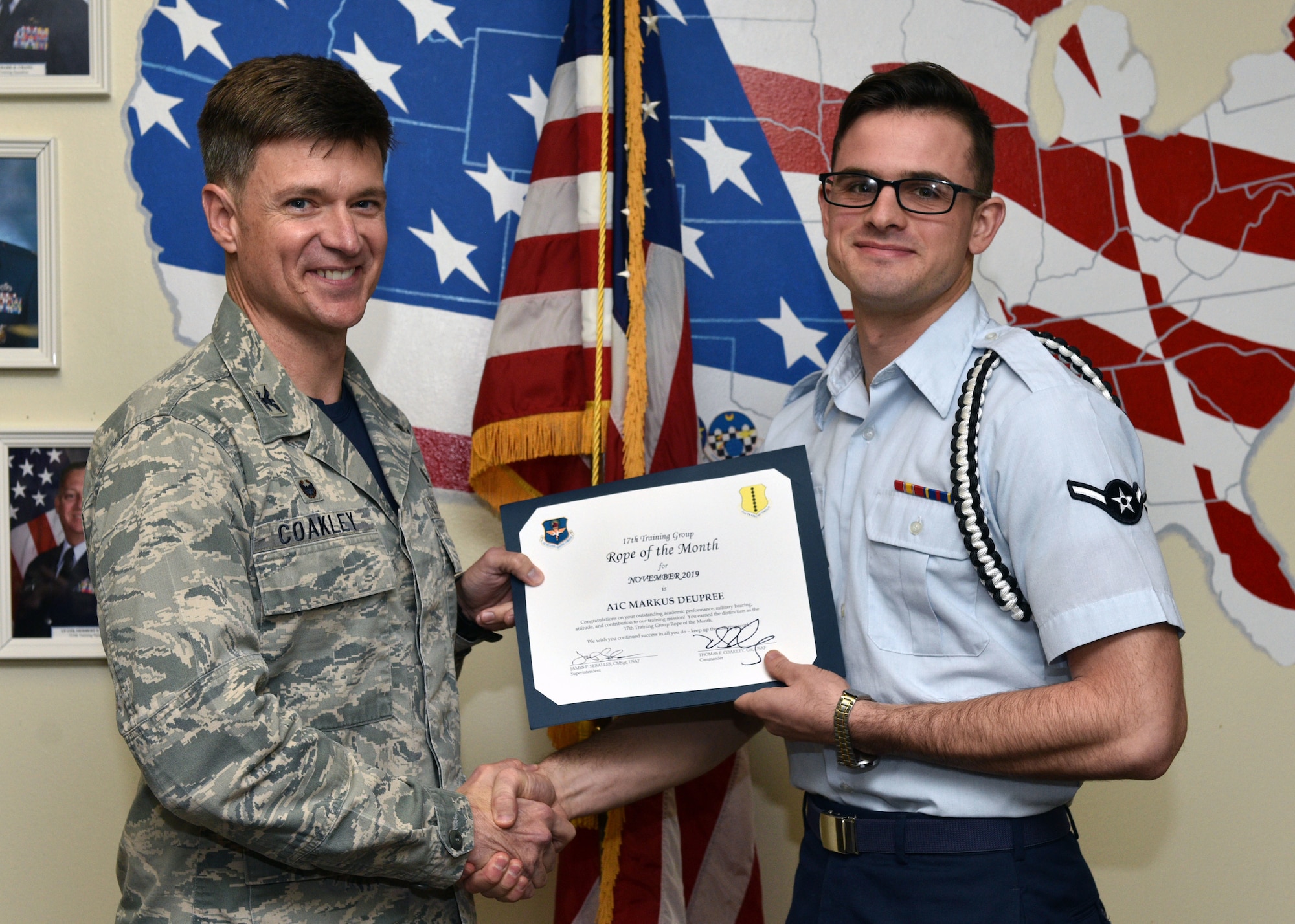 U.S. Air Force Col. Thomas Coakley, 17th Training Group commander, presents the 17th Training Group Rope of the Month award to Airman 1st Class Markus Deupree, 315th Training Squadron student, at Brandenburg Hall on Goodfellow Air Force Base, Texas, Dec. 6, 2019. The 315th TRS’s vision is to develop combat-ready intelligence, surveillance and reconnaissance professionals and promote an innovative squadron culture and identity unmatched across the U.S. Air Force. (U.S. Air Force photo by Airman 1st Class Robyn Hunsinger)