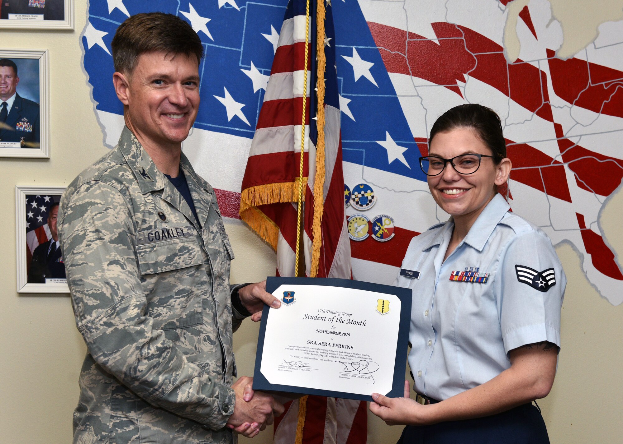 U.S. Air Force Col. Thomas Coakley, 17th Training Group commander, presents the 315th Training Squadron Student of the Month award to Senior Airman Sera Perkins, 315th TRS student, at Brandenburg Hall on Goodfellow Air Force Base, Texas, Dec. 6, 2019. The 315th TRS’s mission is to train, educate, and mentor future intelligence, surveillance, and reconnaissance warriors through innovation. (U.S. Air Force photo by Airman 1st Class Robyn Hunsinger)