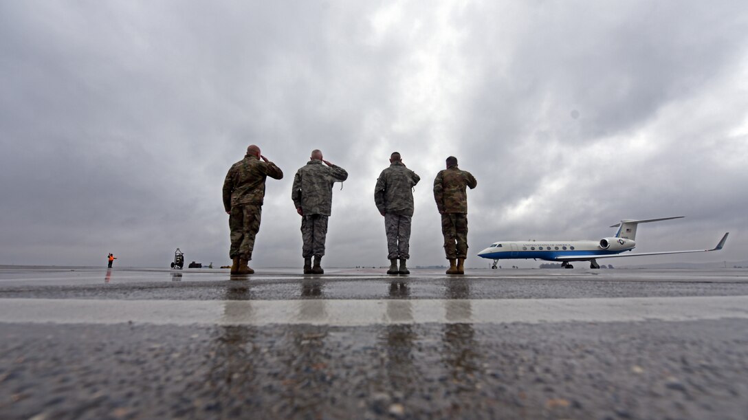 U.S. Airmen salute aircraft.