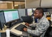 Senior Airman Prince Jarbo, 412th Comptroller Squadron, conducts checks on travel claims at his desk at Edwards Air Force Base, California, Dec. 4. (Air Force photo by Giancarlo Casem)