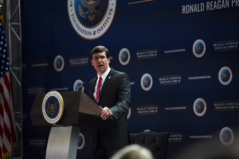 Defense Secretary Dr. Mark T. Esper speaks at a lectern.