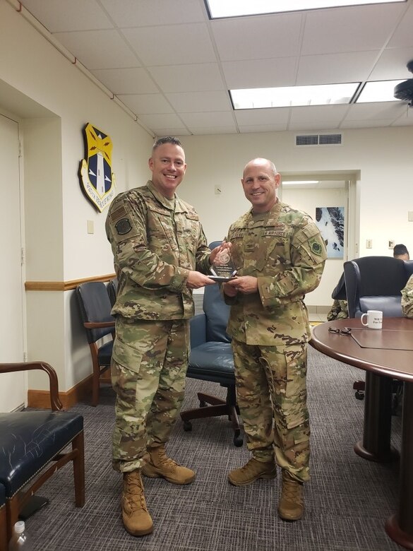 Col. Kurt Matthews (right), 920th Rescue Wing commander, holds the Air Force Reserve Command Recruiting Service Wing of the Year award for fiscal year 2019.